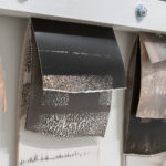 "Mantra #3" (detail 1); Silver gelatin photographic chemigrams, wood, metal; 20" x 39" x 3"; 2019